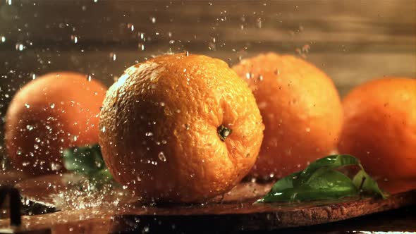 Drops of Water Fall on Fresh Oranges