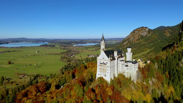 Neuschwanstein castle with autumn color tree background, Aerial side view