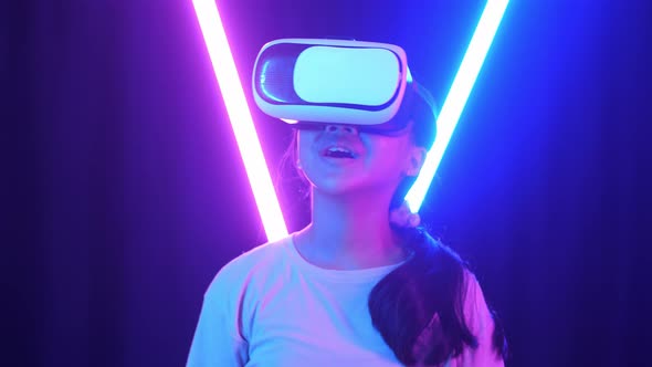 Vr, Futuristic, Excited Asian Young Girl Using Virtual Reality Headset With Neon Light