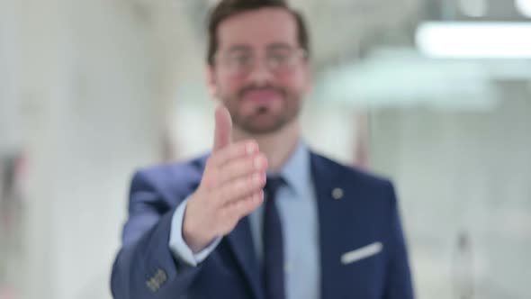 Young Businessman Doing Hand Shake Gesture