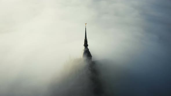 Amazing Aerial Shot of Thick Fog Covering Majestic Mont Saint Michel Fortress Castle Spire at