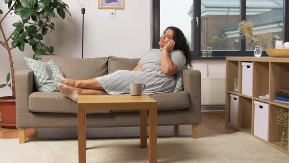 Happy Young Woman Calling on Smartphone at Home