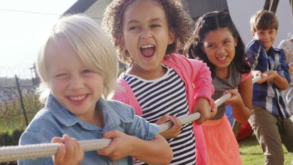 Group of happy friend playing tug of war 4k