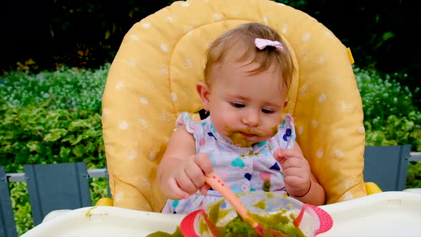 Baby is Eating Broccoli Puree