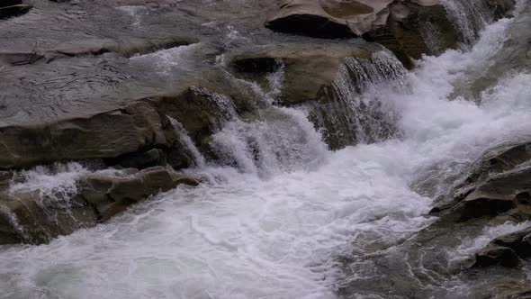 Waterfall Prut in the Winter. Rapid Flow of Water From a Mountain Creek and Stone Rapids with Snow