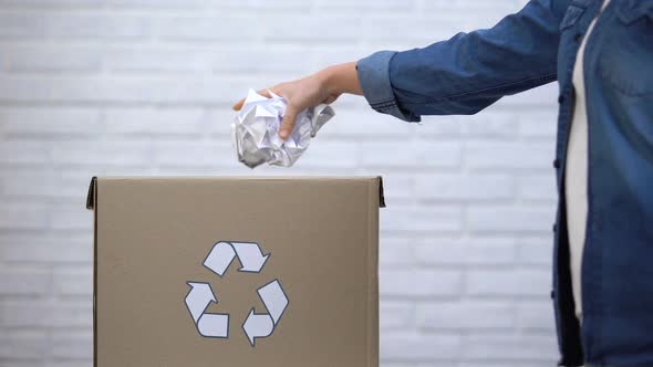 Person Throwing Paper Into Trash Bin, Waste Sorting Concept, Recycling System