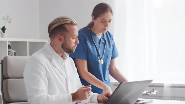 Professional medical doctors working in hospital office. Physician and the young nurse.