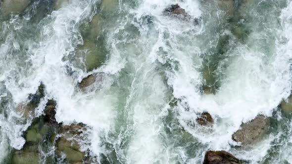 Top view of a quick current: background showing white foam in a mountain river