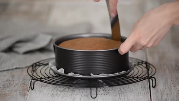 Woman Takes Out Chocolate Sponge Cake From the Mold on the Table