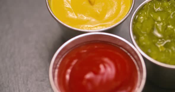 Detailed orbit of condiments, ketchup, mustard, and relish.