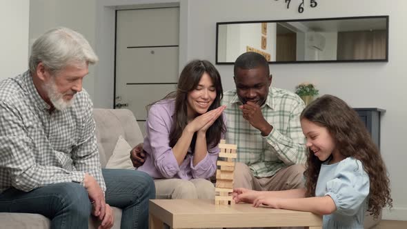 Multiethnic Family of Different Age Generations Playing Board Game at Home