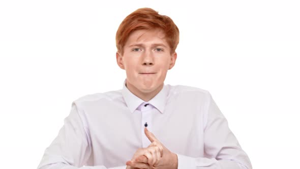 Young Ginger Caucasian Boy Standing on White Background in Excitement Awaiting for His Sport Team