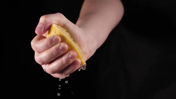 Citrus fruit - squeezing a lemon by hand