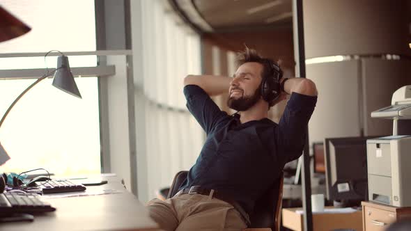 Man Relaxing In Office.Businessman Listening Music On Workplace Enjoy.Stress Free Man Relaxing