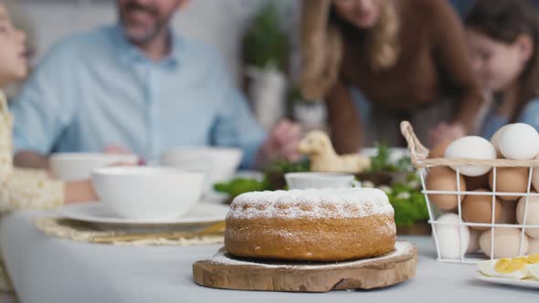 Detail of easter cake on the table and people in the background. Shot with RED helium camera in 8K.