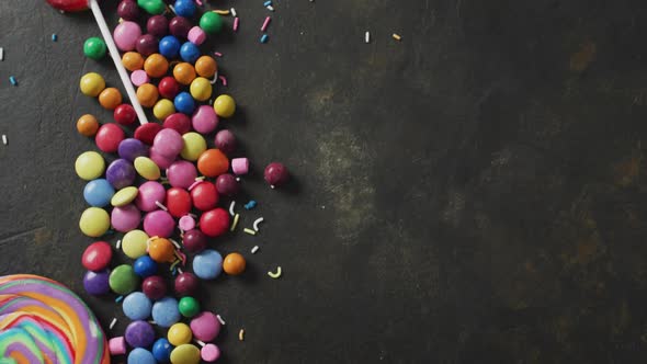 Video of colourful lentils and lollipop on grey background