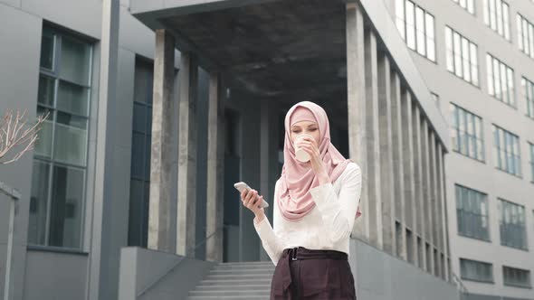 Close Up of Muslim Woman in Hijab with Modern Smartphone and Takeaway Coffee in