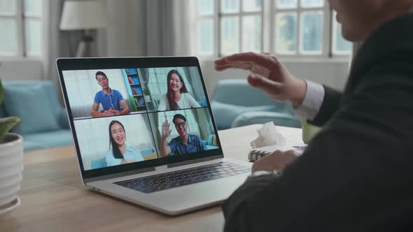 Asian Businessman Wearing Business Suit Having Video Call With His Colleagues On Computer