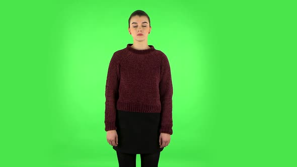 Woman Standing and Looks at the Camera. Green Screen