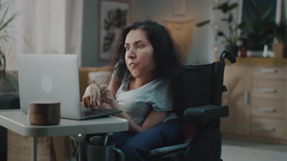 Woman in a Wheelchair Surfing Internet