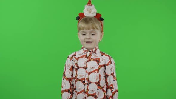 Happy Beautiful Little Girl in a Shirt with a Santa Claus. Christmas. Chroma Key