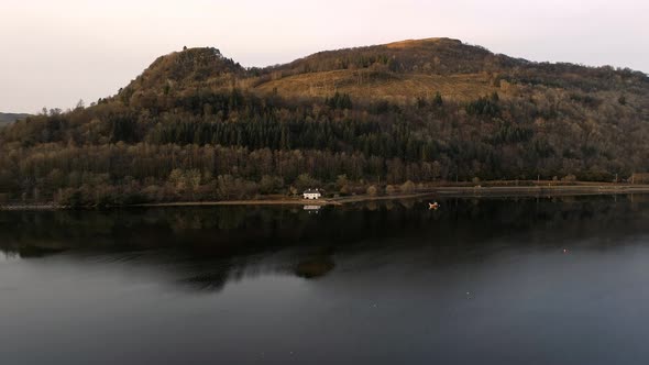 House Reflected in a Still Lake