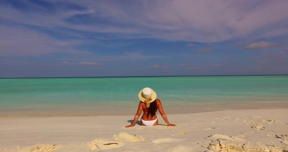 Sexy beauty model travelling in the sun at the beach on summer white sandy and blue