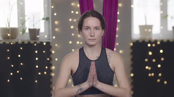 Young Woman Stretching Her Leg Using Yoga Hammock