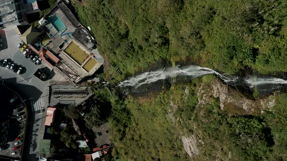 Vertical Shot Of Cascada de la Virgen With People Swimming On Public Pool At Baños de Agua Santa, Ec