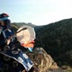 A Shaman Knocks on a Tambourine Sitting on a Rock on Top of a Mountain. - VideoHive Item for Sale