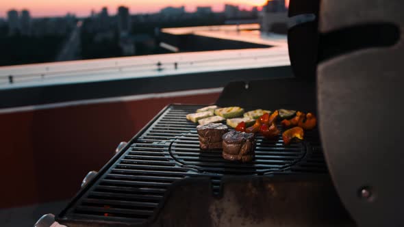 BBQ close-up: filet mignon steak and grilled vegetables cooking