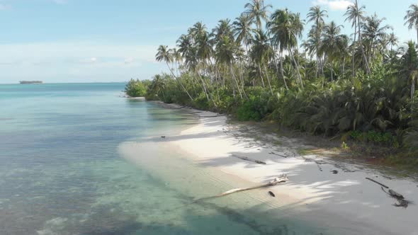 Aerial: flying over exotic white sand beach tropical island secluded destination away from it all