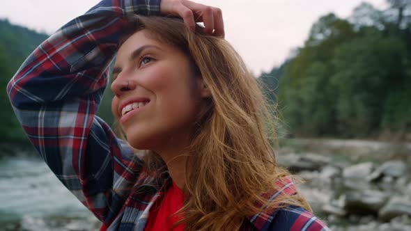 Woman Standing at River in Mountains