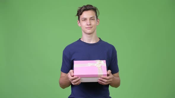 Young Handsome Teenage Boy with Gift Box