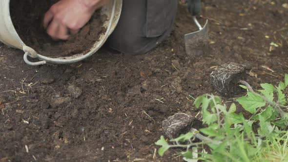 Mixing compost and soil in bucket gardening