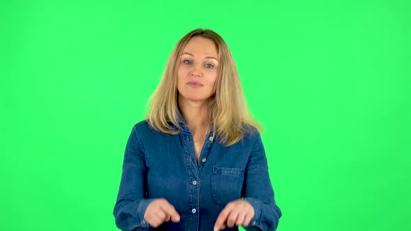 Portrait of Fair Woman Is Smiling and Showing Heart with Fingers Then Blowing Kiss. Green Screen