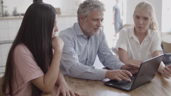 Content Grey-haired Businessman Typing on Laptop Keyboard