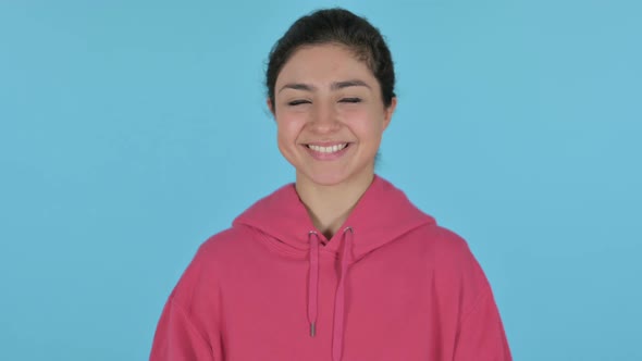 Indian Girl Smiling at Camera  Blue Background