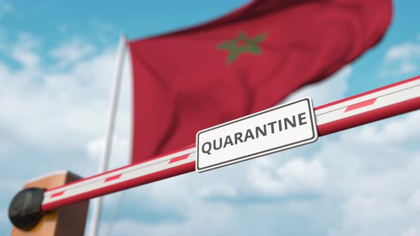 Opening Barrier with QUARANTINE Sign at the Moroccan Flag