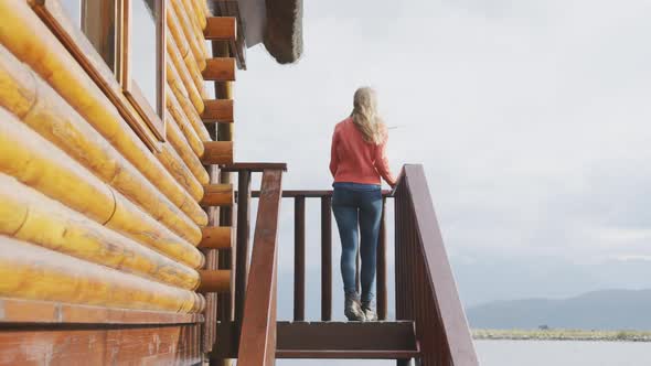 Caucasian woman spending time at home, putting hands in the air