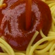 Pouring ketchup on spaghetti, tomato sauce falling on pasta, close up - VideoHive Item for Sale