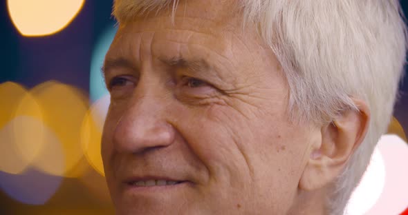 Bokeh Close Up Shot of Senior Gray Haired Man Looking Away