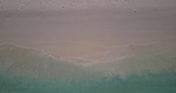 Daytime birds eye copy space shot of a white sand paradise beach and blue ocean background in colour