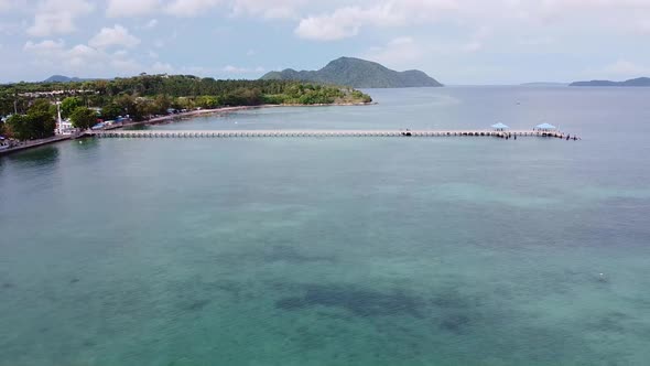 A Long Pier Extending out into Tropical Waters Aerial