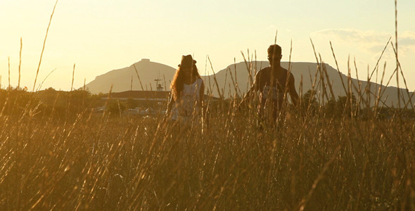 Walking Couple At Sunset