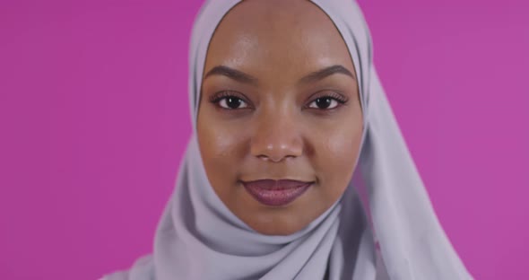 Young Modern Muslim Afro Beauty Wearing Traditional Islamic Clothes Against Plastic Pink Background