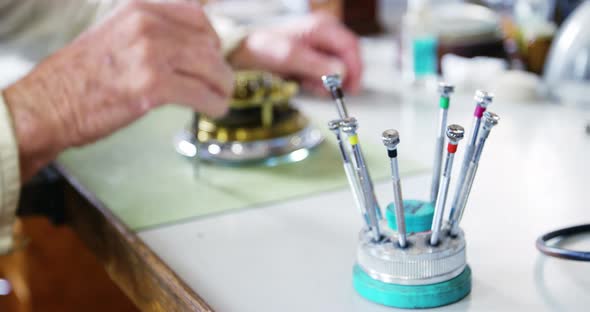 Horologist repairing a watch