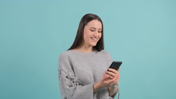 Close Up of an Young Woman Watching a Funny Video on Smartphone