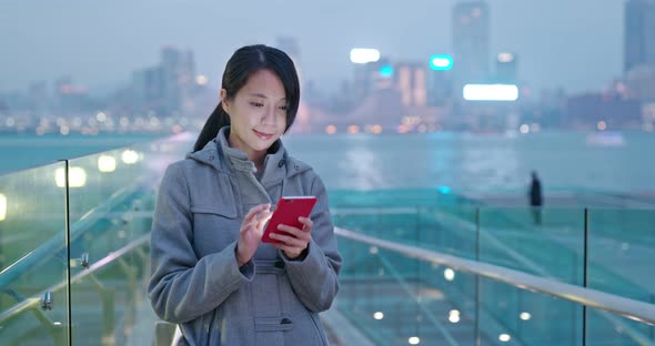 Woman look at mobile phone in city