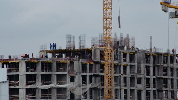 Workers build a house until late at night